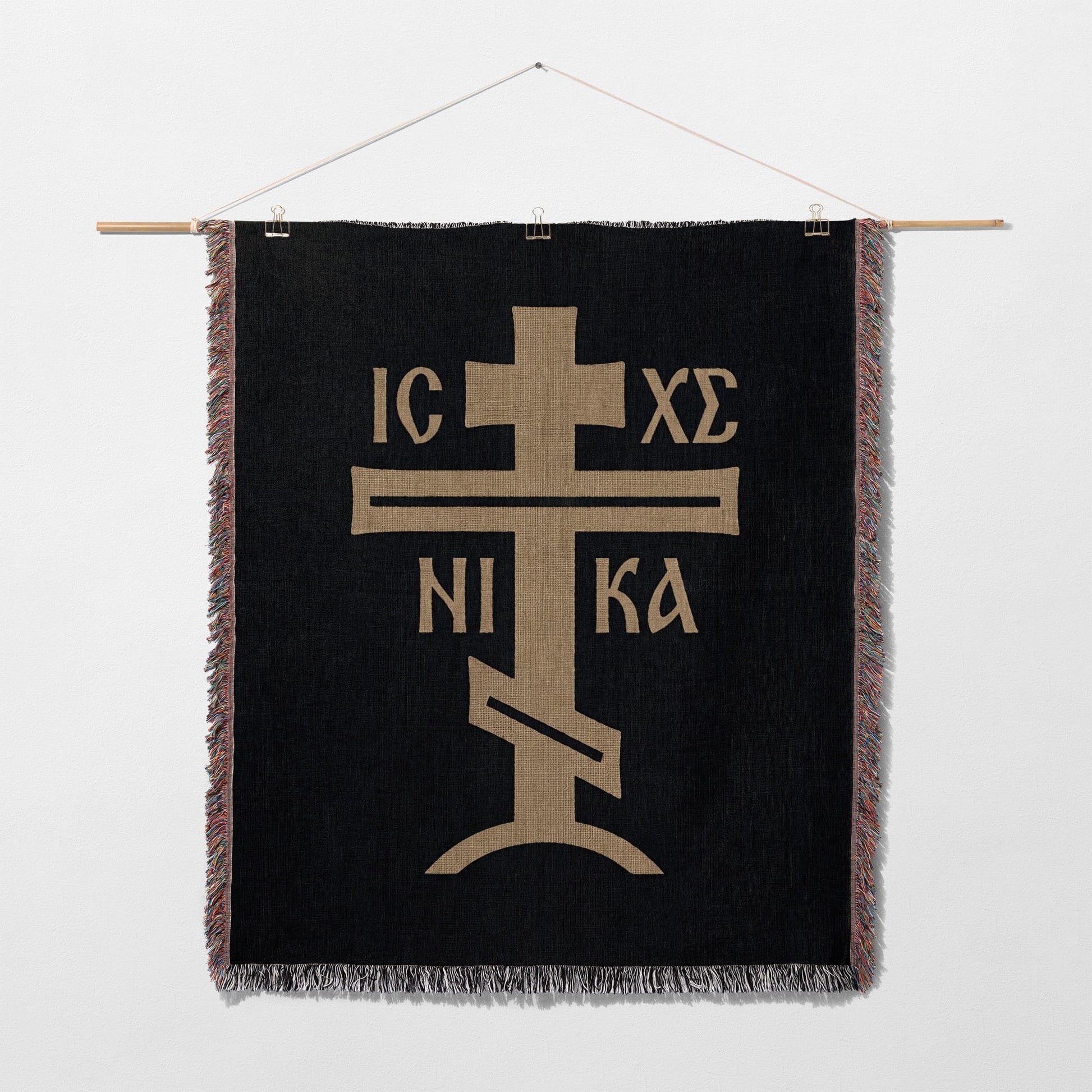 Black tapestry with gold Orthodox Christian cross and inscription IC XC NIKA.