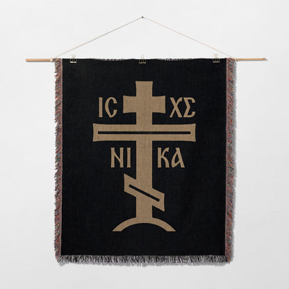 Black tapestry with gold Orthodox Christian cross and inscription IC XC NIKA.