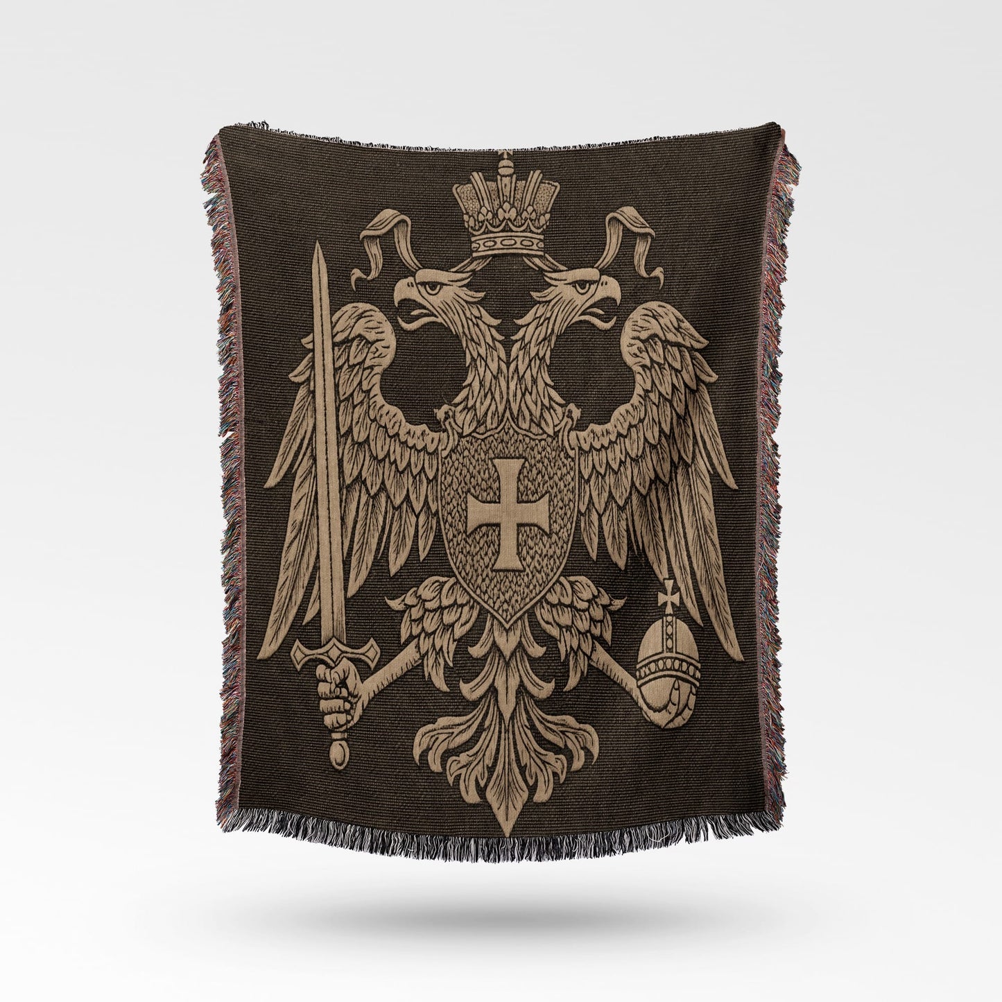 Double-headed eagle coat of arms with sword and orb on a dark patterned throw.