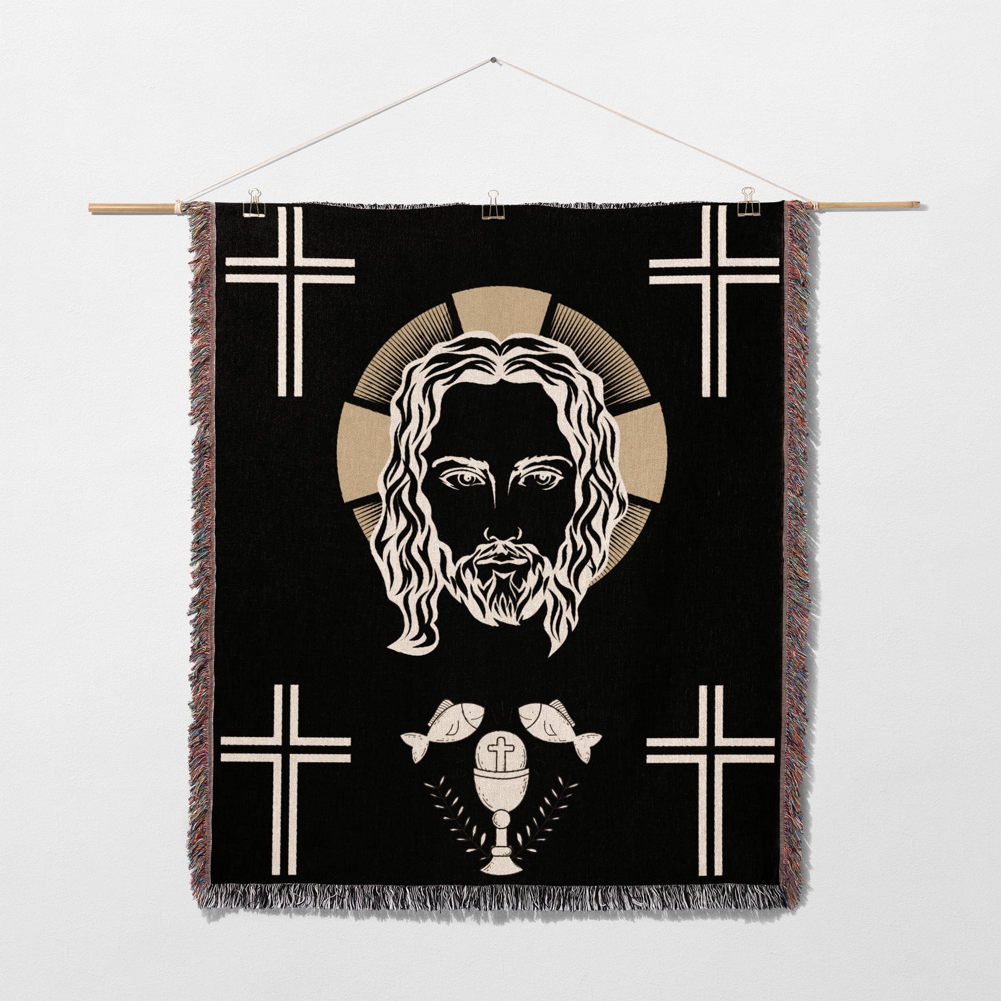 Jesus Christ face with crosses, chalice, and fish on a black tapestry.