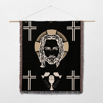 Jesus Christ face with crosses, chalice, and fish on a black tapestry.