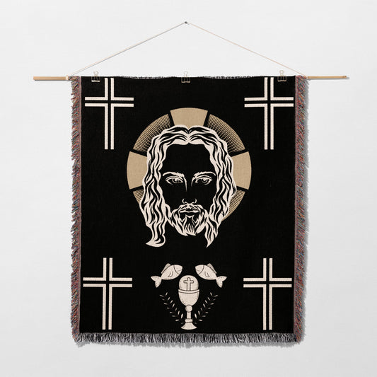Jesus Christ face with crosses, chalice, and fish on a black tapestry.