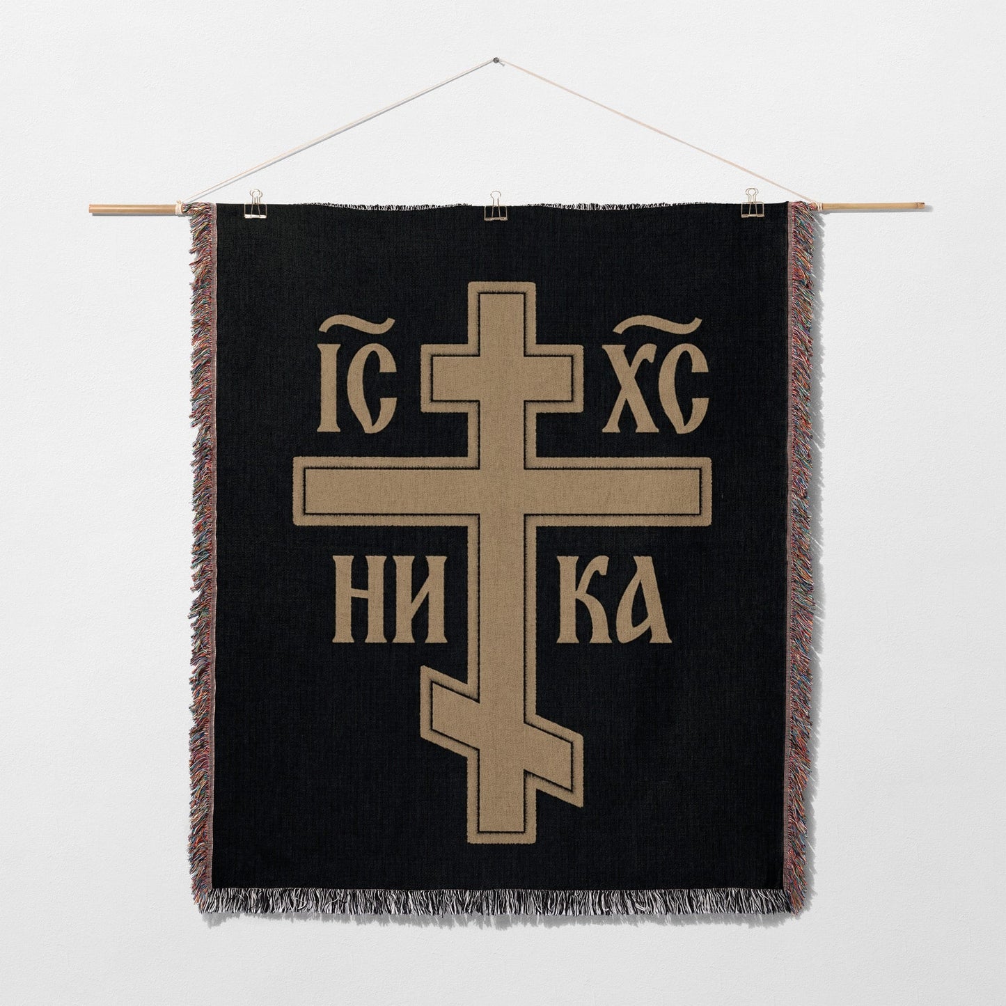 Black tapestry with gold Orthodox Christian cross and Greek inscription.