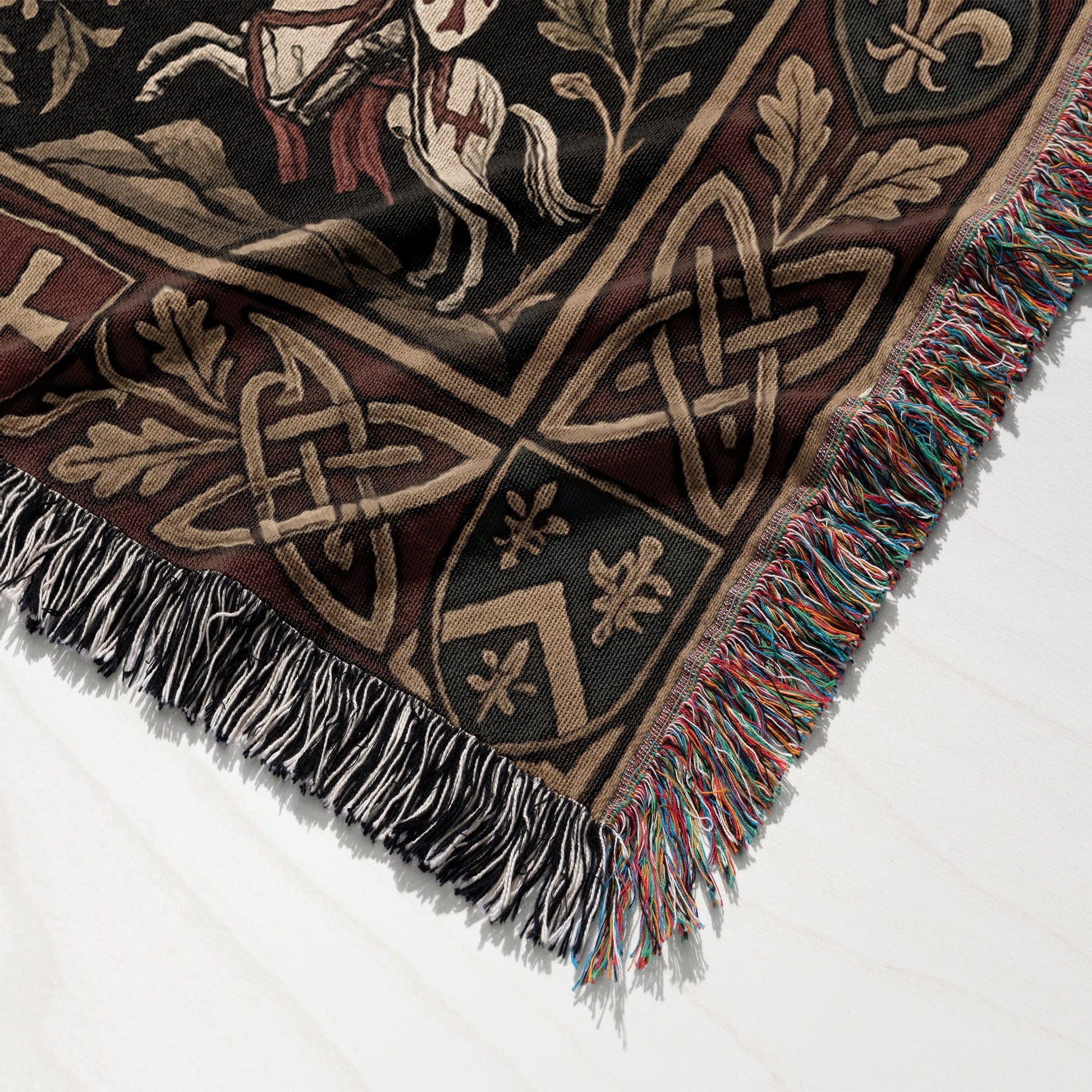 Woven tapestry blanket with knight on horseback and Celtic knot patterns.