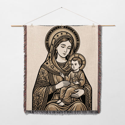 Tapestry of the Virgin Mary holding the infant Jesus, with ornate border.