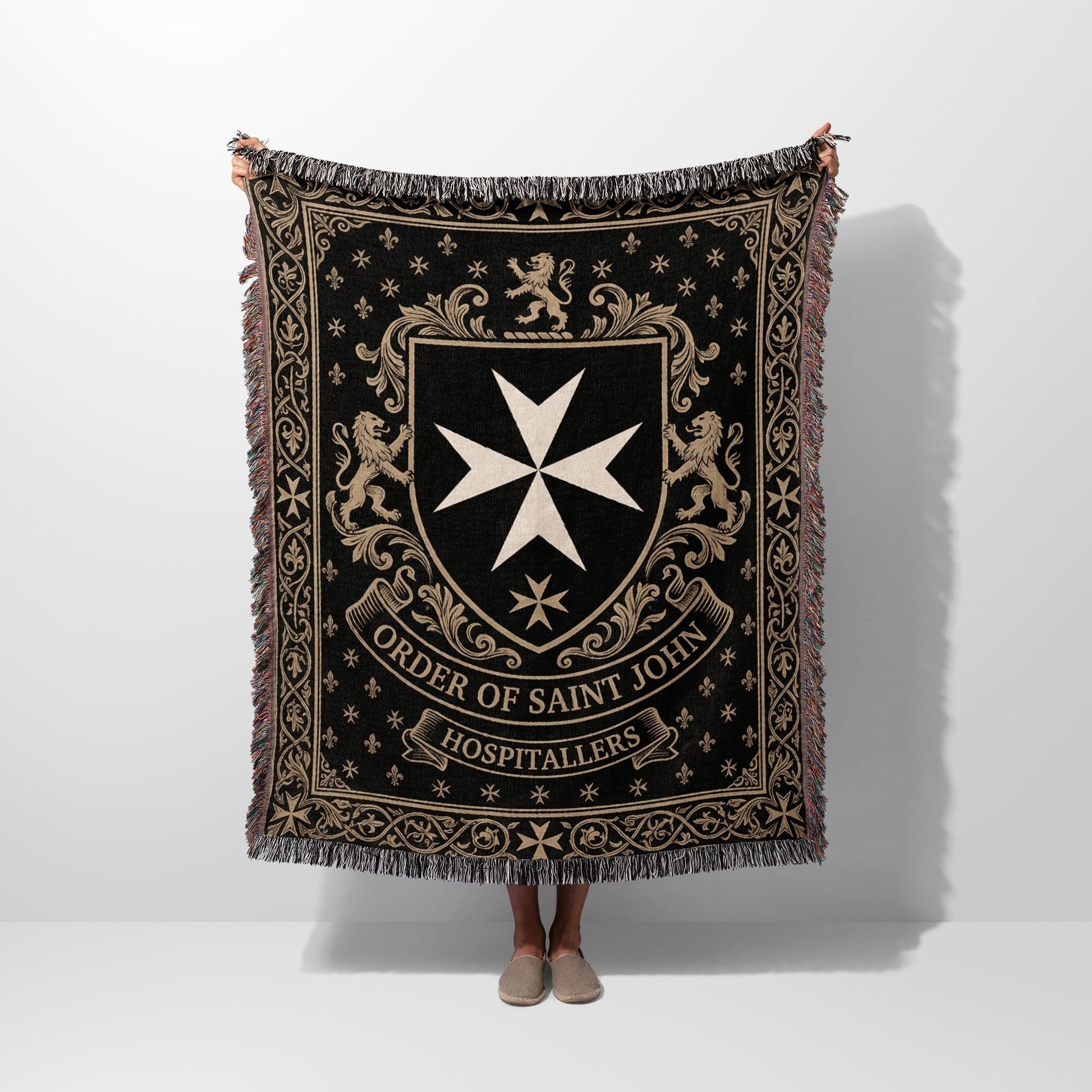 Black tapestry blanket with Order of Saint John Hospitallers crest and lions.