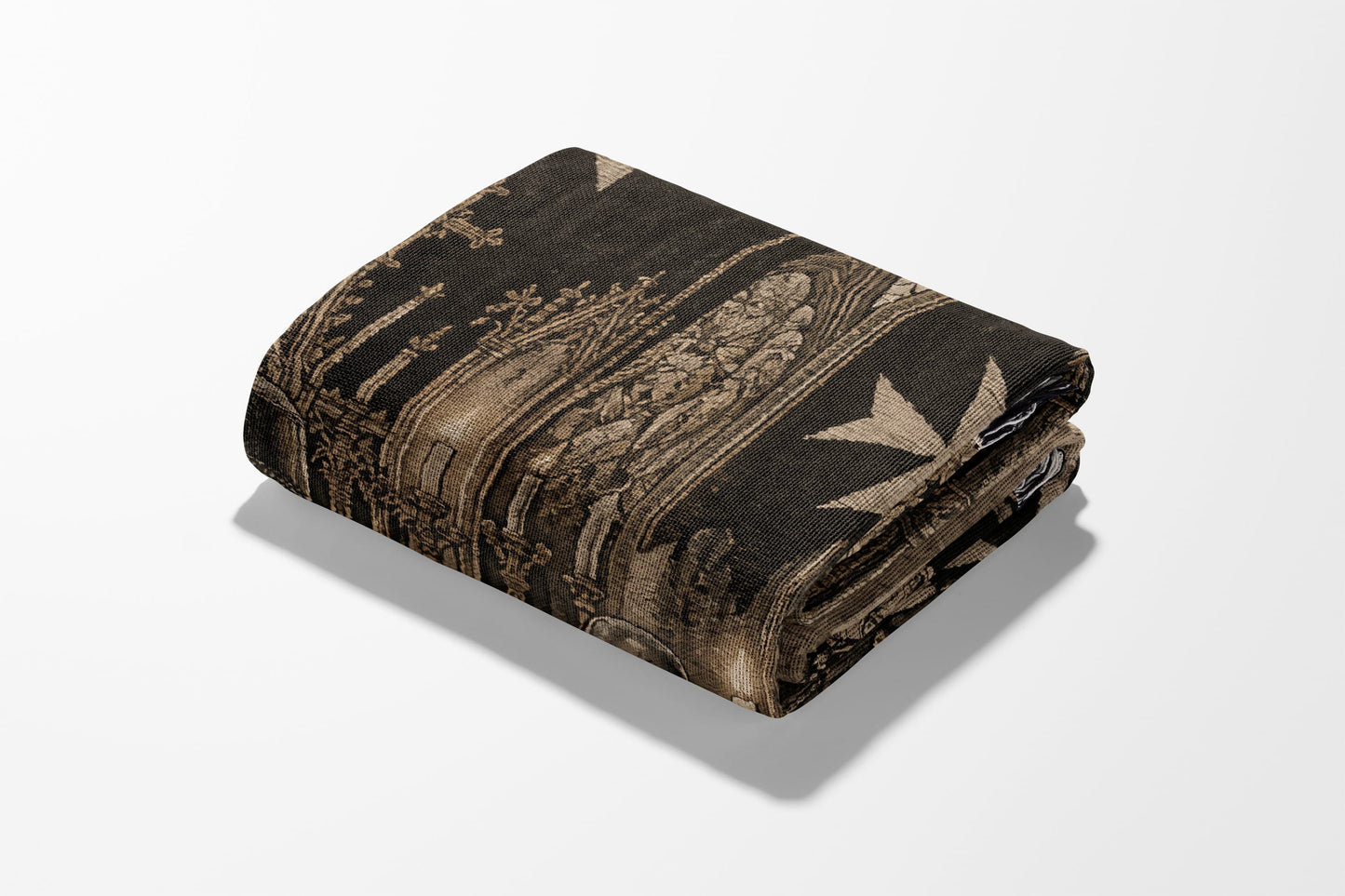 Folded blanket with intricate gothic architecture and Maltese cross pattern.
