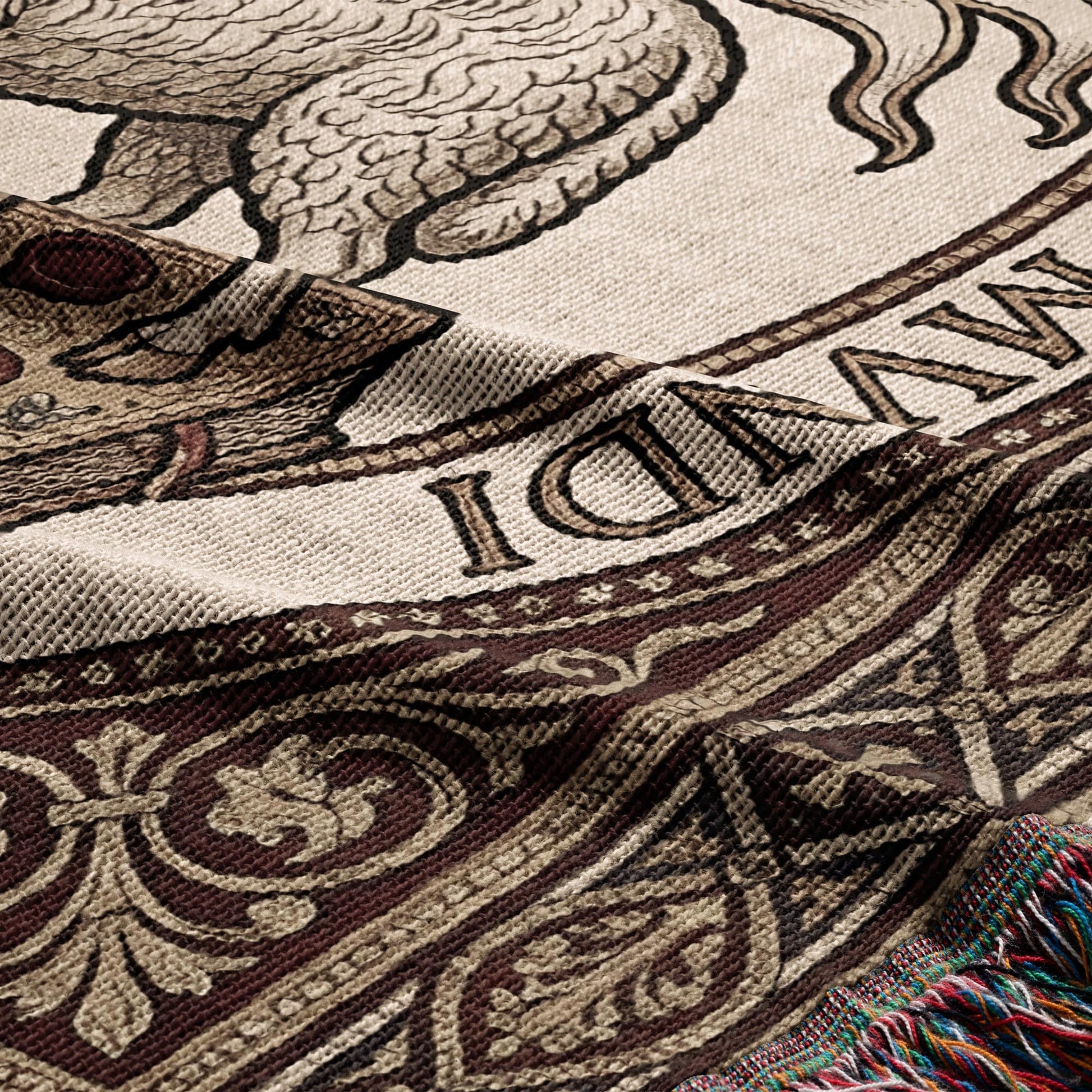 Woven tapestry with ornate border and partial text, showing intricate detail.