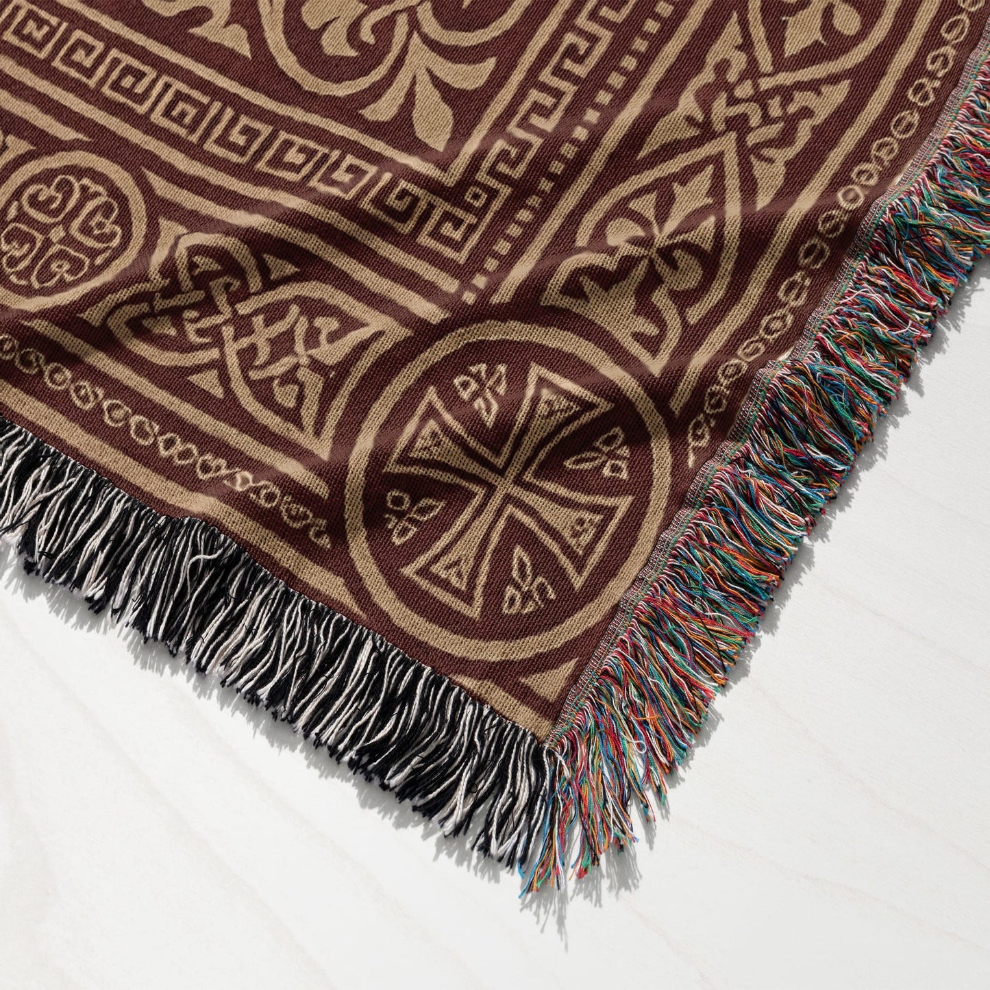 Brown woven throw blanket with ornate geometric and Celtic knot patterns.