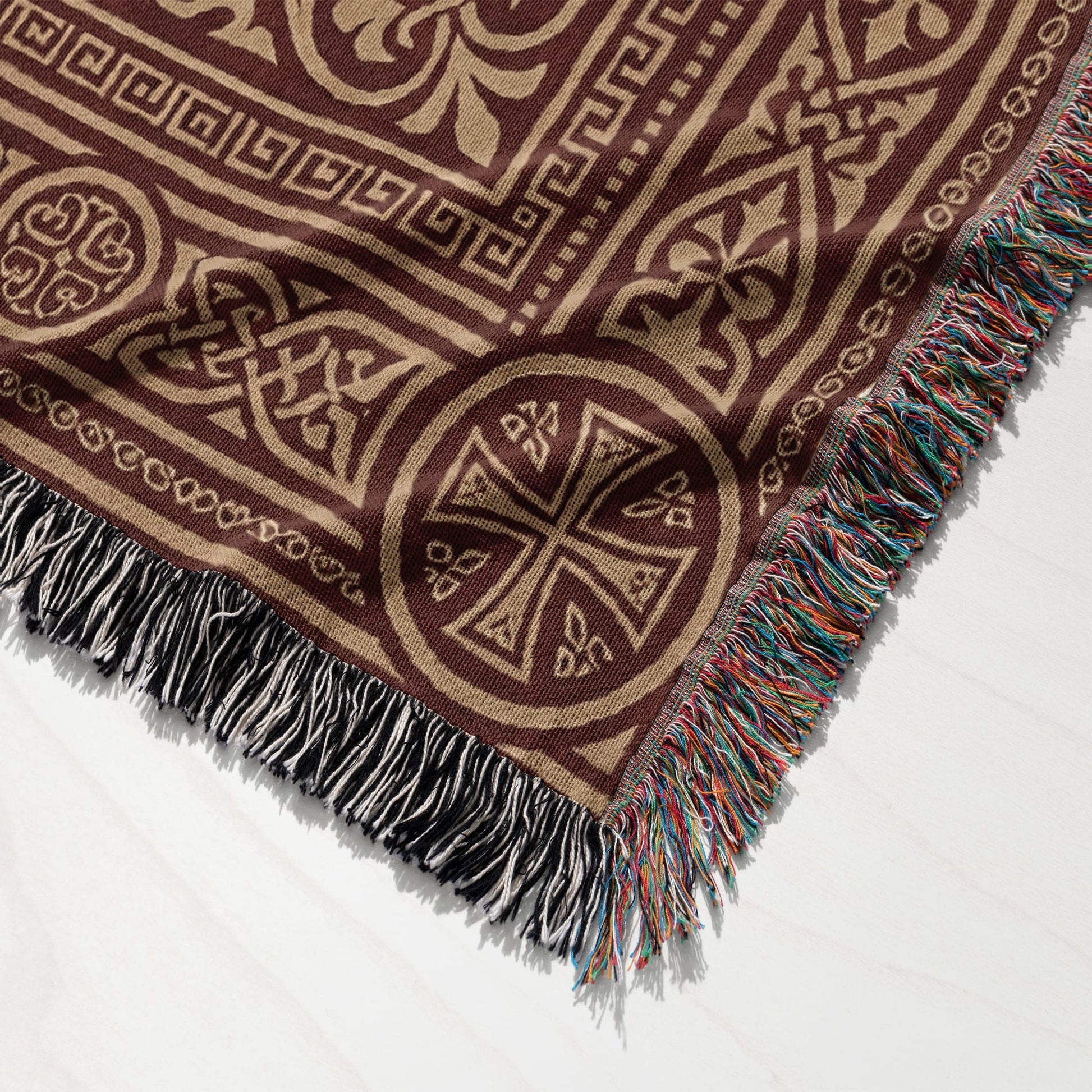 Brown woven throw blanket with ornate geometric and Celtic knot patterns.