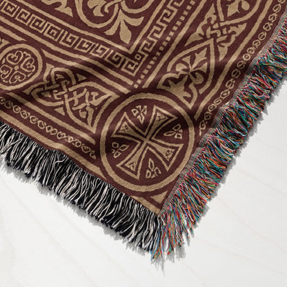 Brown woven throw blanket with ornate geometric and Celtic knot patterns.