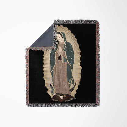 Woven blanket with an image of Our Lady of Guadalupe in gold and brown.