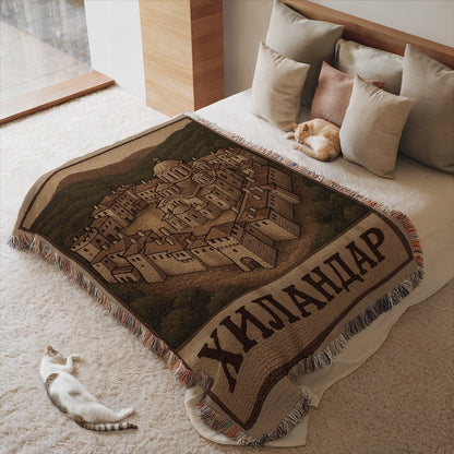 Cozy blanket with detailed village scene and fringe details