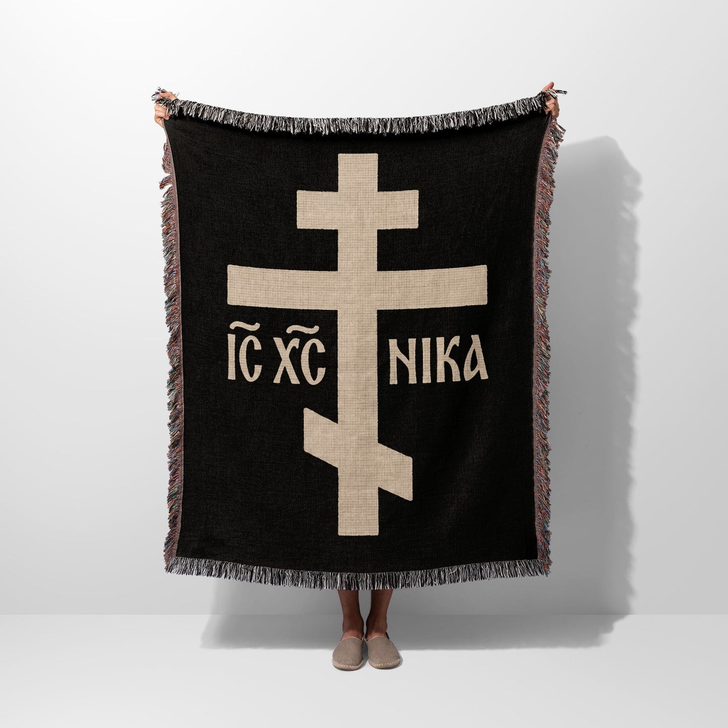 Black throw blanket with a large tan Orthodox cross and "IC XC NIKA" text.