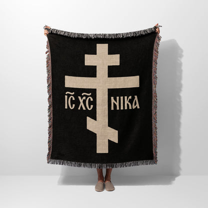 Black throw blanket with a large tan Orthodox cross and "IC XC NIKA" text.