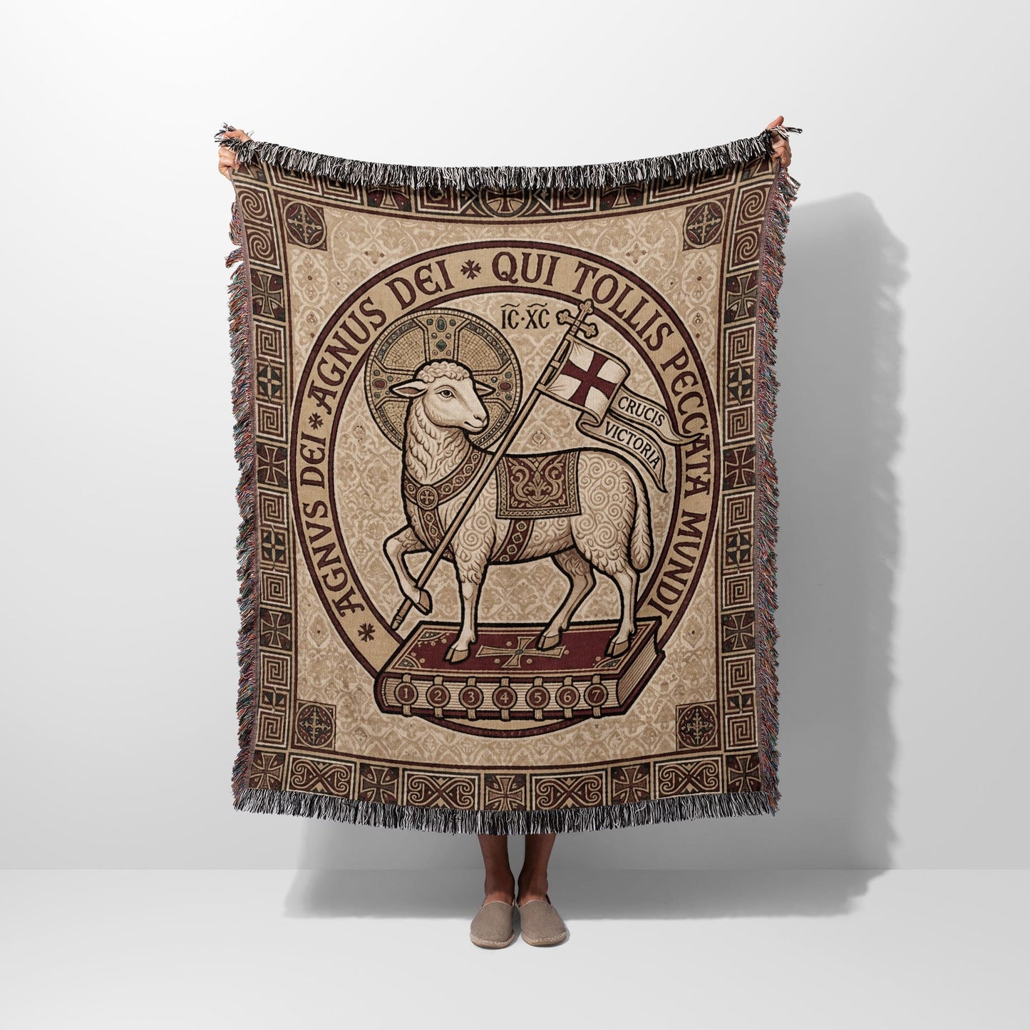 Lamb of God tapestry blanket with Latin text on a book.