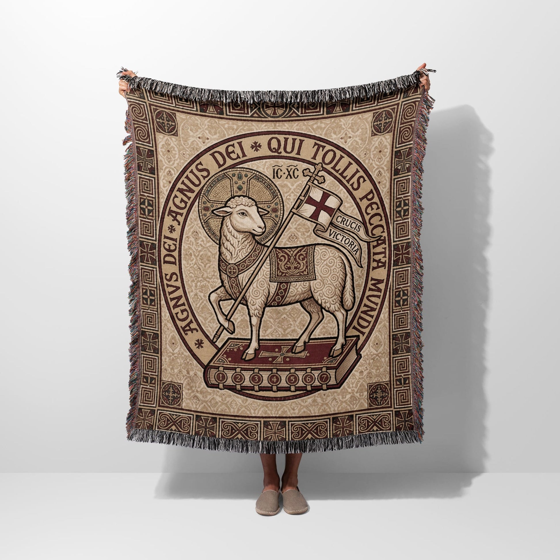 Lamb of God tapestry blanket with Latin text on a book.