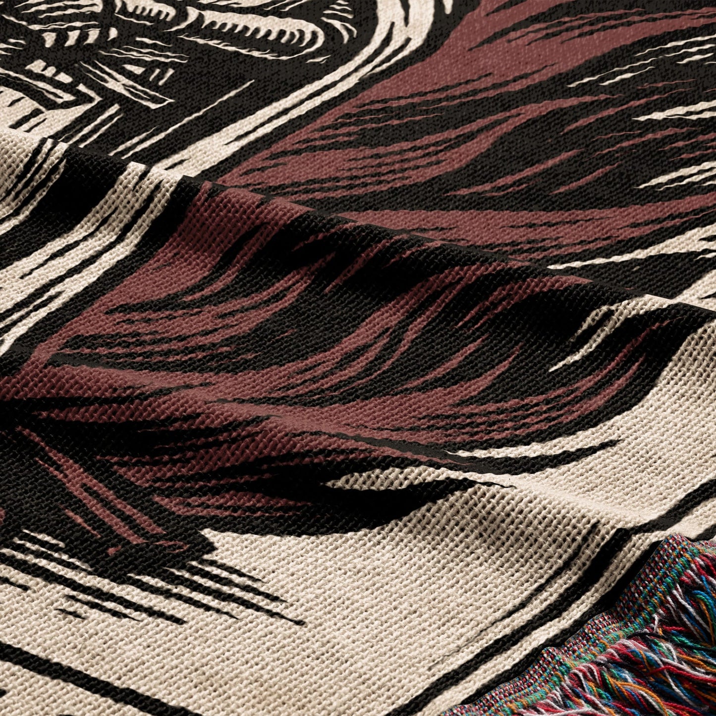 Close-up of a woven blanket with a dark brown and black abstract design.
