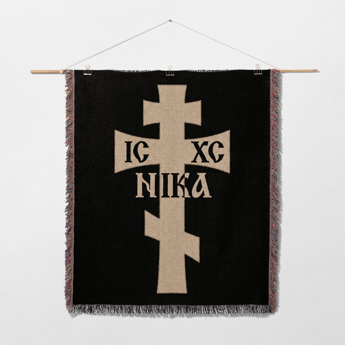 Tan Christian cross with IC XC NIKA text on black woven tapestry.