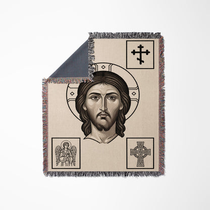 Beige woven blanket featuring a central depiction of Jesus with surrounding Christian symbols.