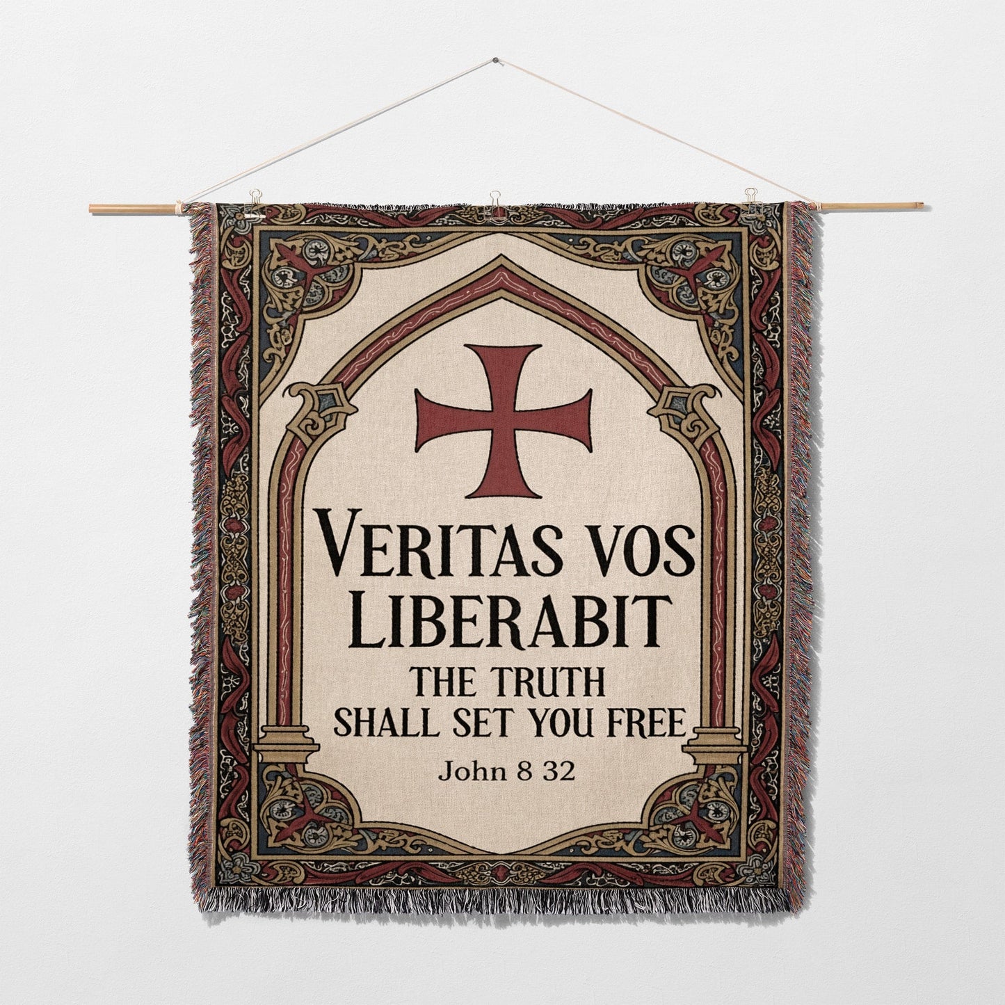 Tapestry with a cross and Latin text "Veritas vos liberabit. The truth shall set you free. John 8:32".