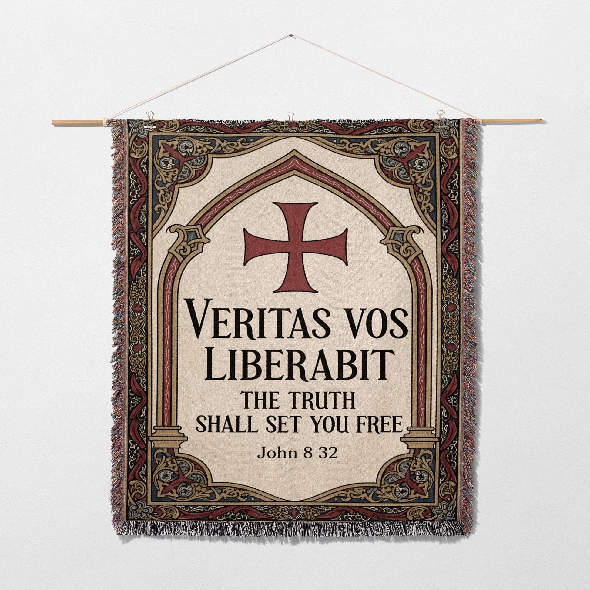 Tapestry with a cross and Latin text "Veritas vos liberabit. The truth shall set you free. John 8:32".