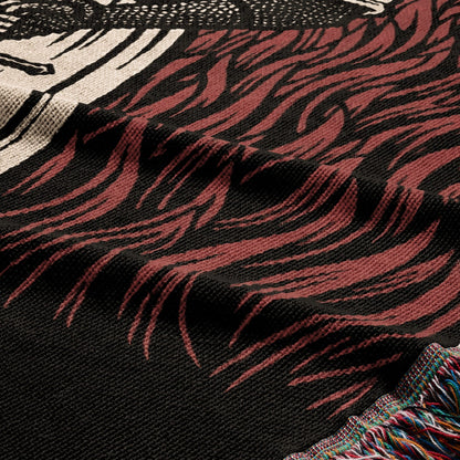 Woven blanket with black background and abstract red and white pattern.
