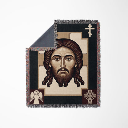 Woven blanket featuring a portrait of Jesus Christ and religious symbols.