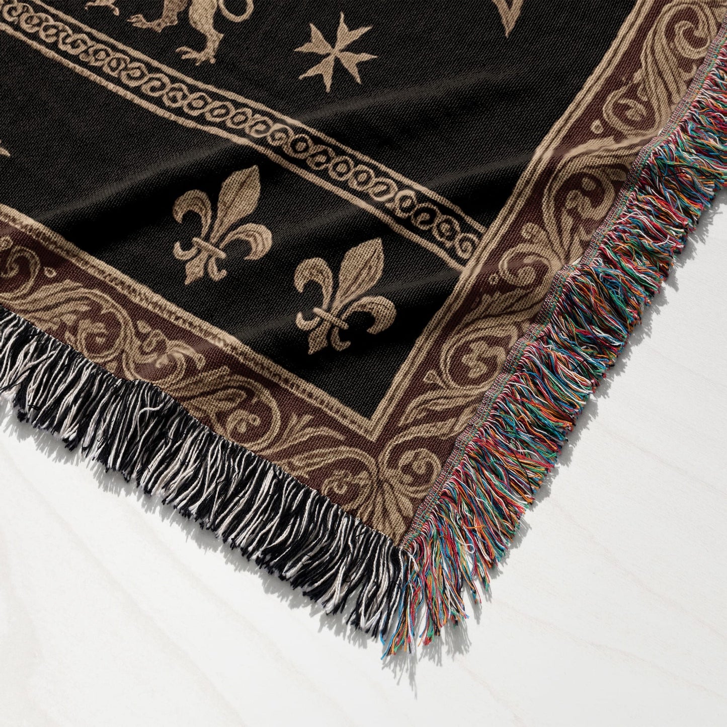 Black blanket with neutral gothic-inspired border and fleur-de-lis pattern.