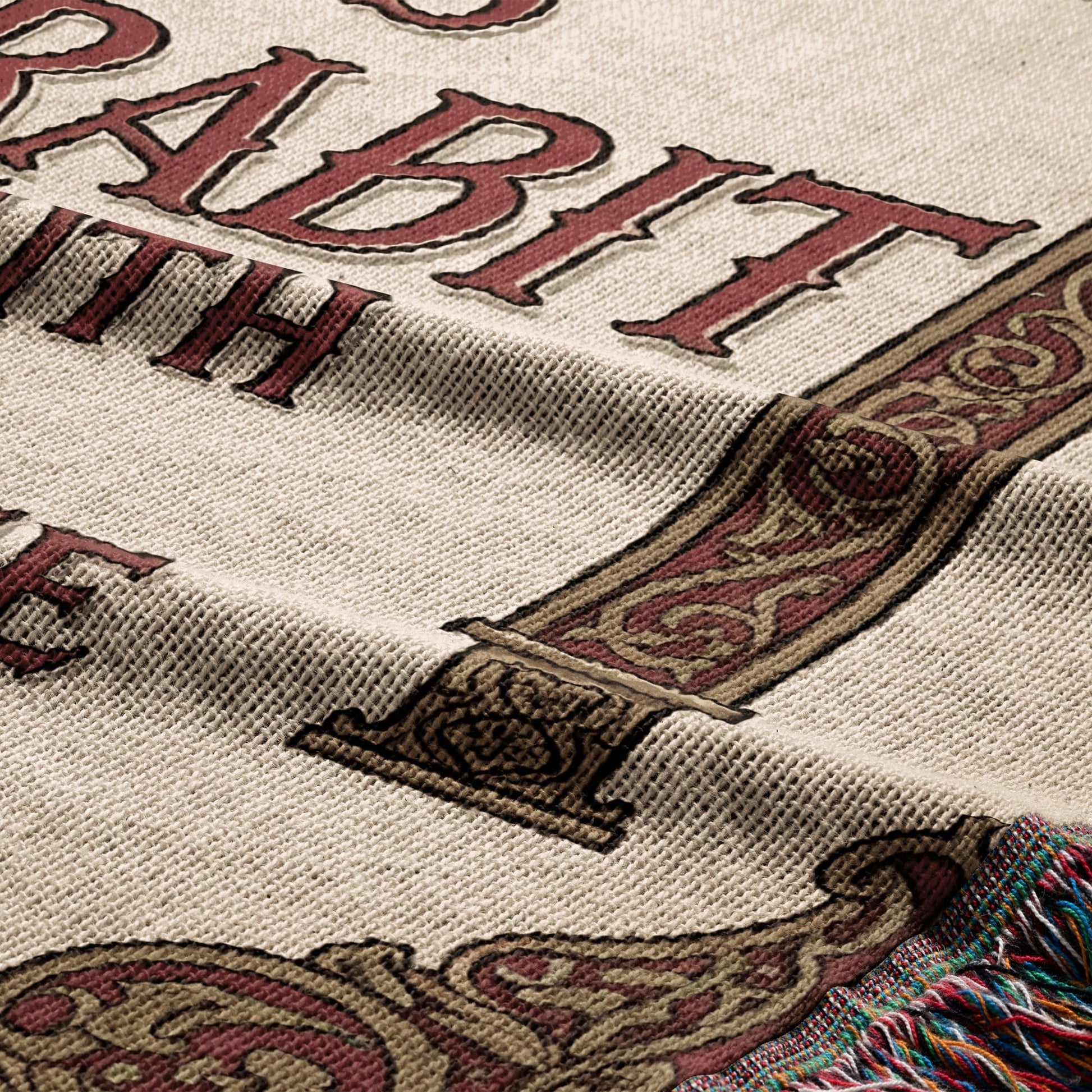 Tapestry with "HABIT" in ornate lettering and decorative border.