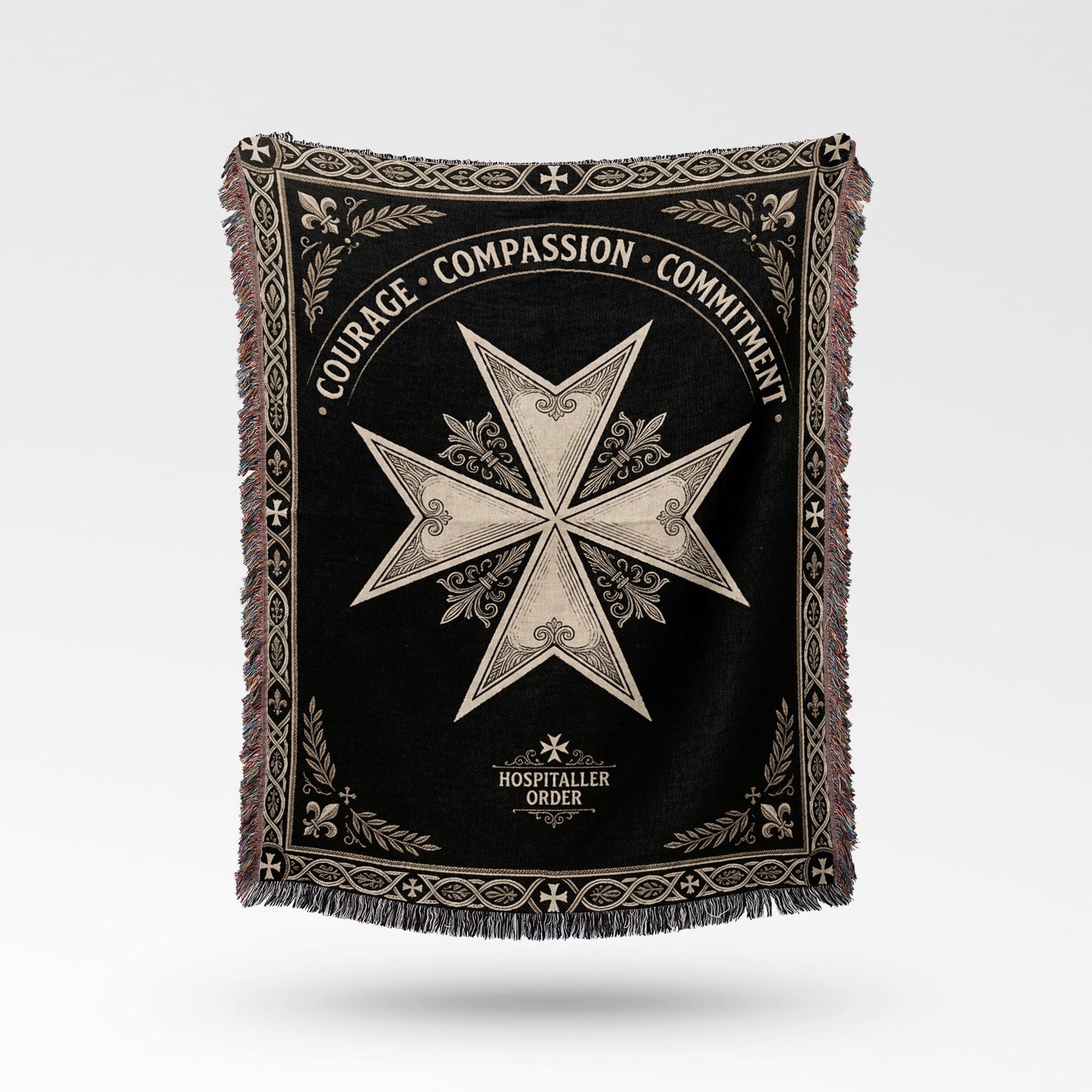Black blanket with a white Maltese cross and "COURAGE COMPASSION COMMITMENT" text.