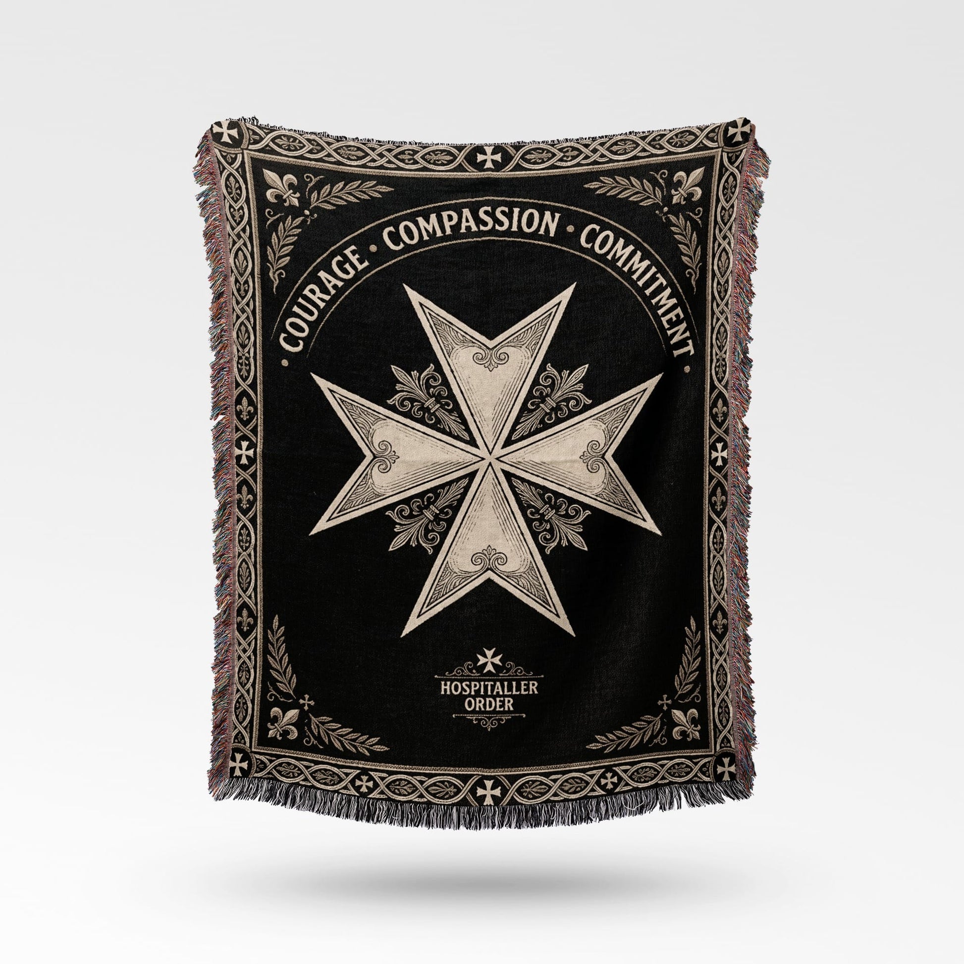Black blanket with a white Maltese cross and "COURAGE COMPASSION COMMITMENT" text.