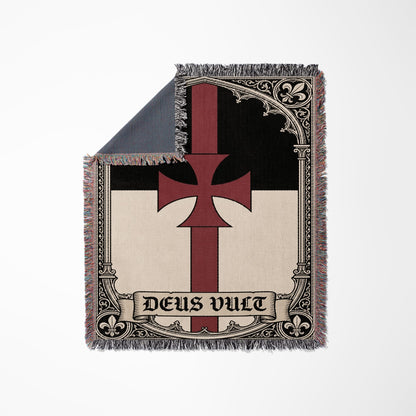 Templar cross with "Deus Vult" text on a woven blanket.