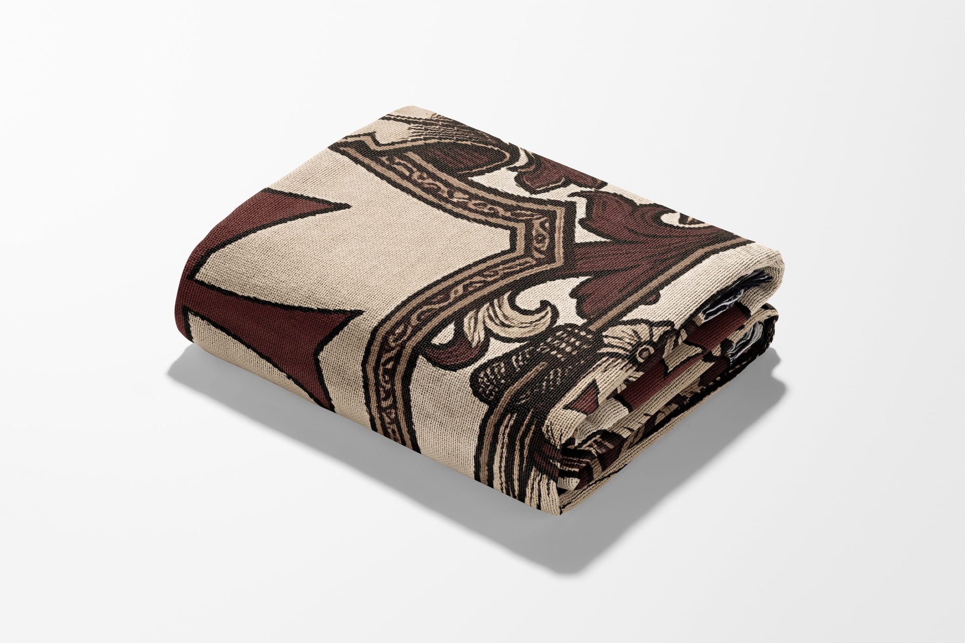 Folded blanket with ornate brown and beige damask pattern.