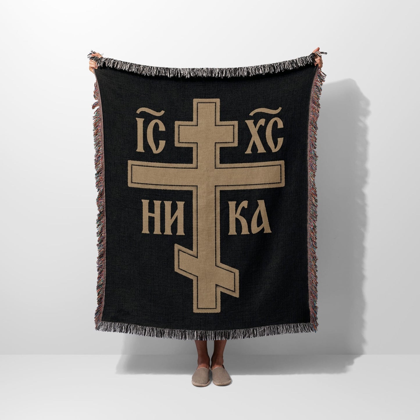 Woven throw blanket with large gold Eastern Orthodox cross and text on black.