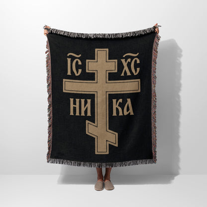 Woven throw blanket with large gold Eastern Orthodox cross and text on black.