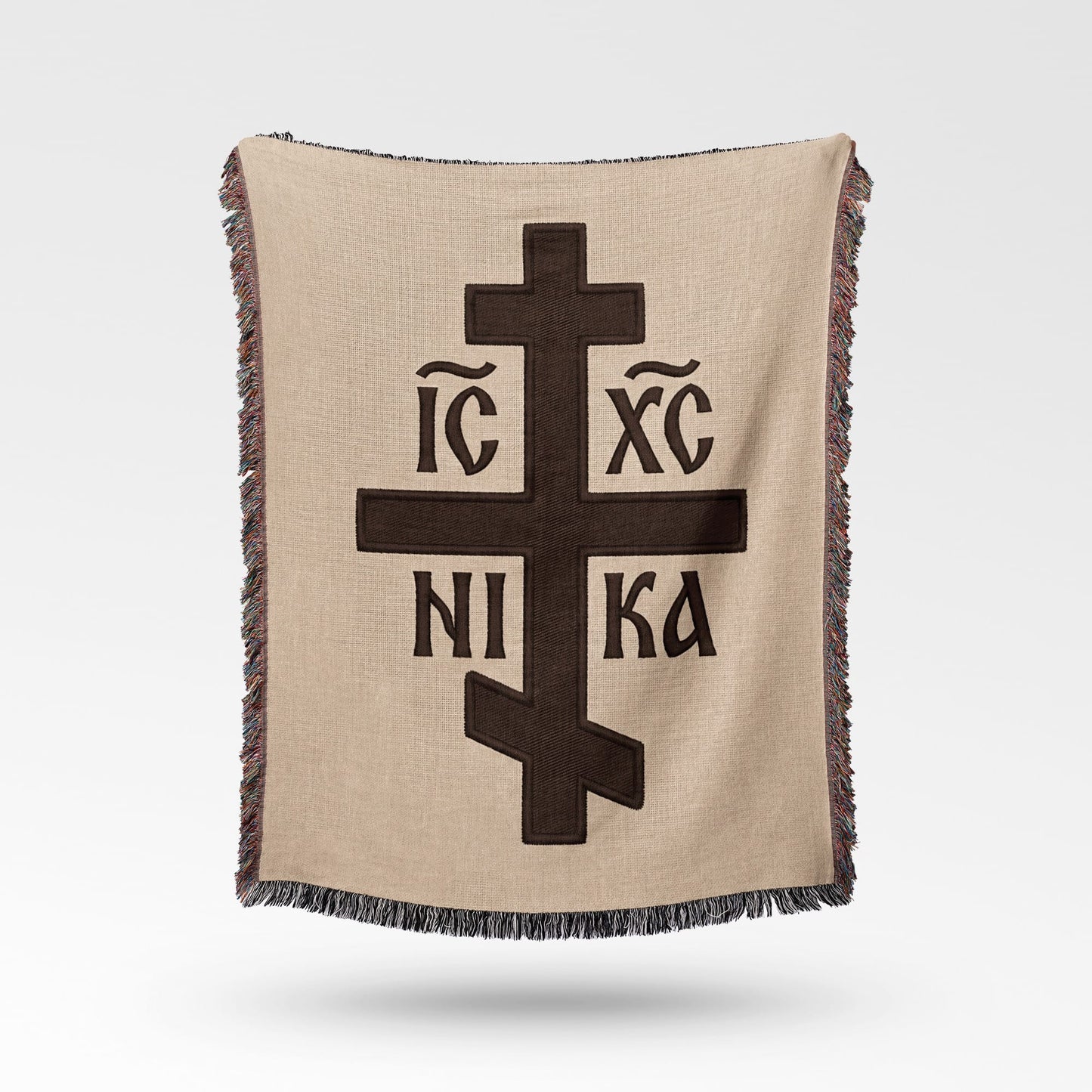 Brown blanket with Orthodox Christian cross symbol and text.