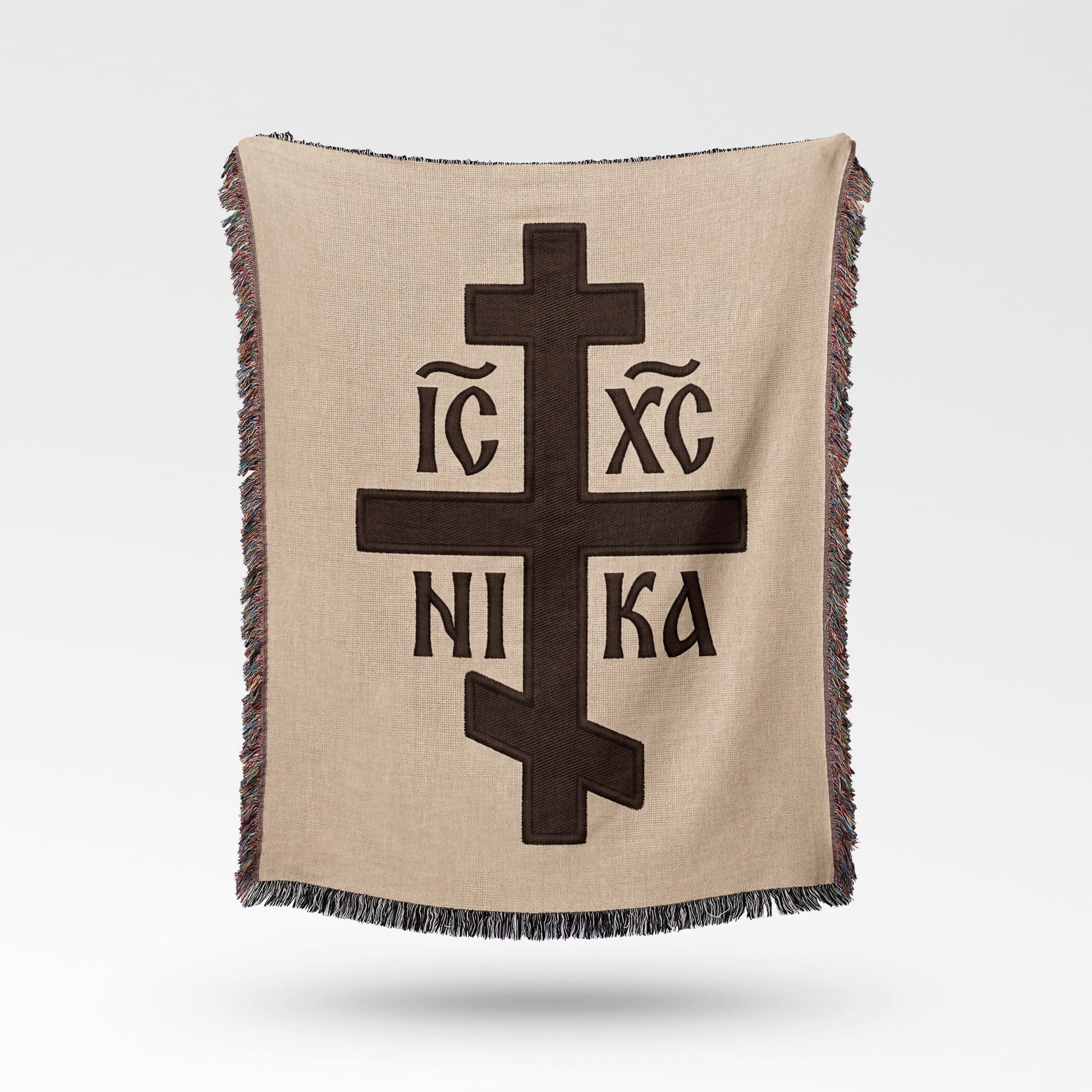 Brown blanket with Orthodox Christian cross symbol and text.