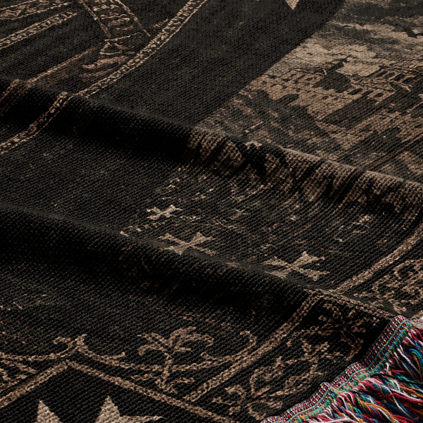Dark tapestry with intricate historical patterns and a colorful fringed edge.