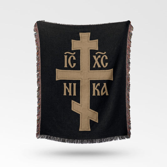 Orthodox cross with IC XC NIKA inscription on black fringed throw.