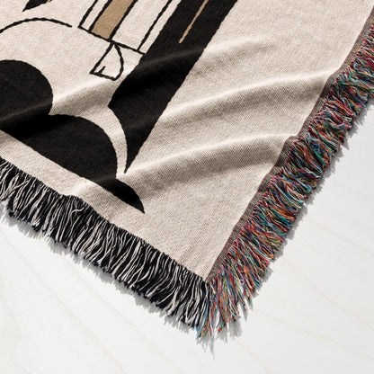 Tapestry woven throw blanket with colorful fringed edges, featuring a large black letter B.