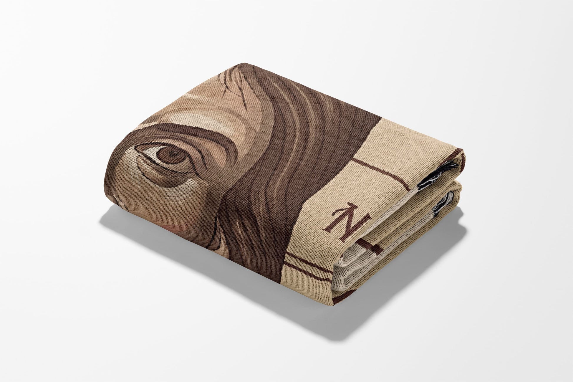 Folded blanket featuring a close-up portrait with partial text.