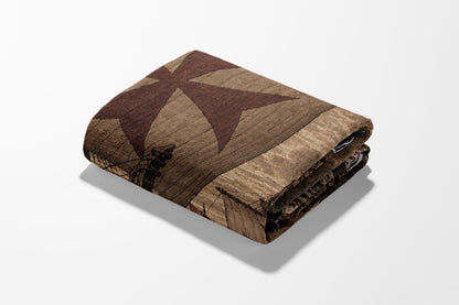 Folded blanket with Templar cross and distressed wood pattern.
