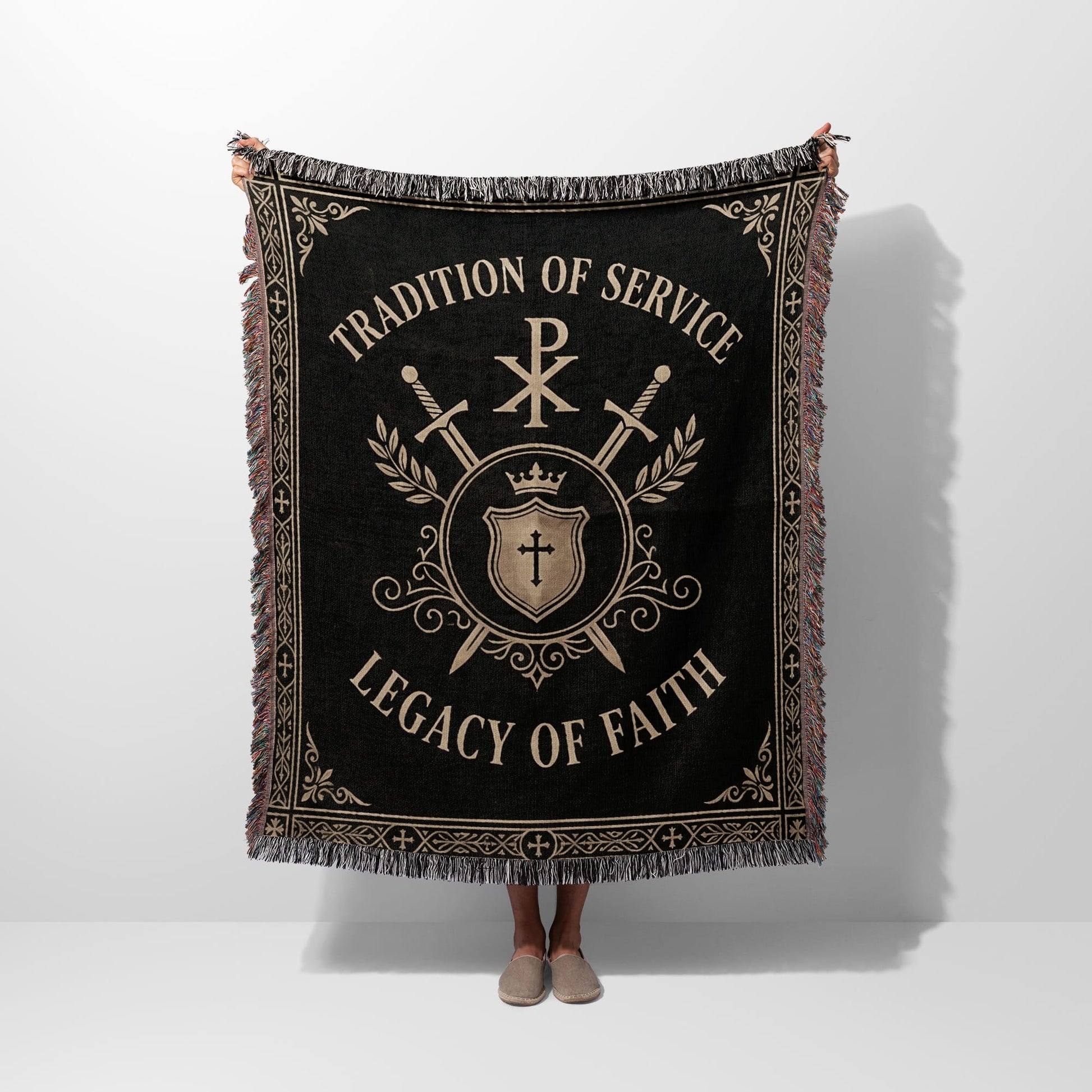 Black woven blanket with crest, swords, and text "TRADITION OF SERVICE LEGACY OF FAITH".