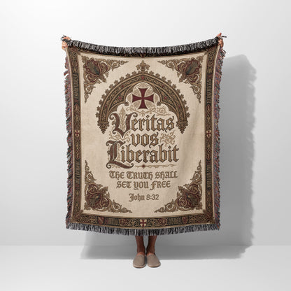 Woven blanket with a central cross and Latin inscription "Veritas vos liberabit".