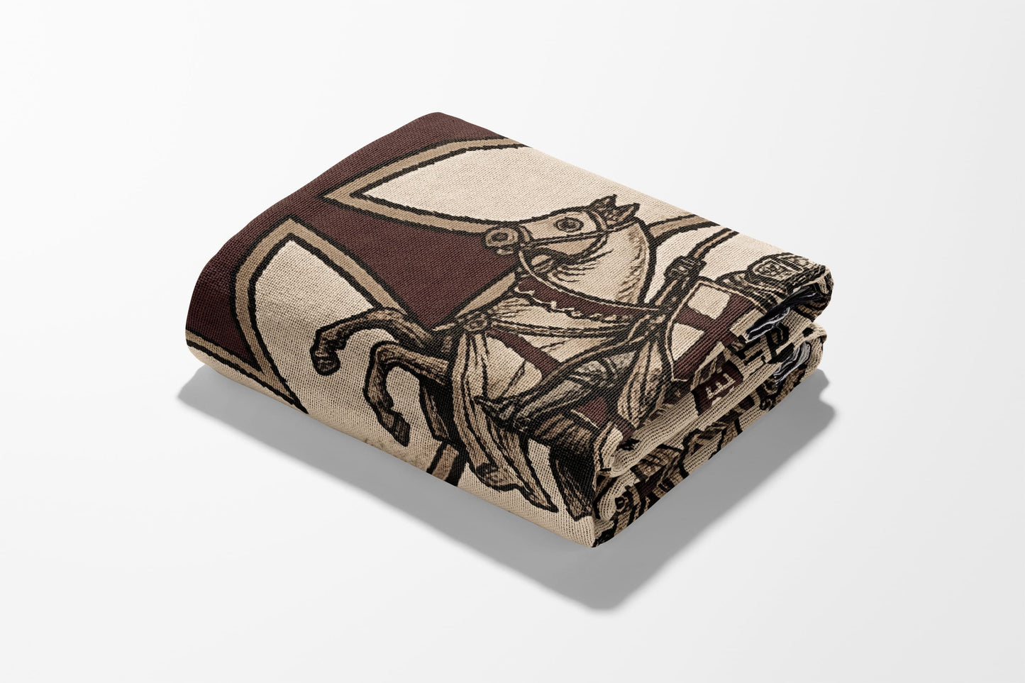 Folded blanket with a knight on horseback and cross emblem pattern.