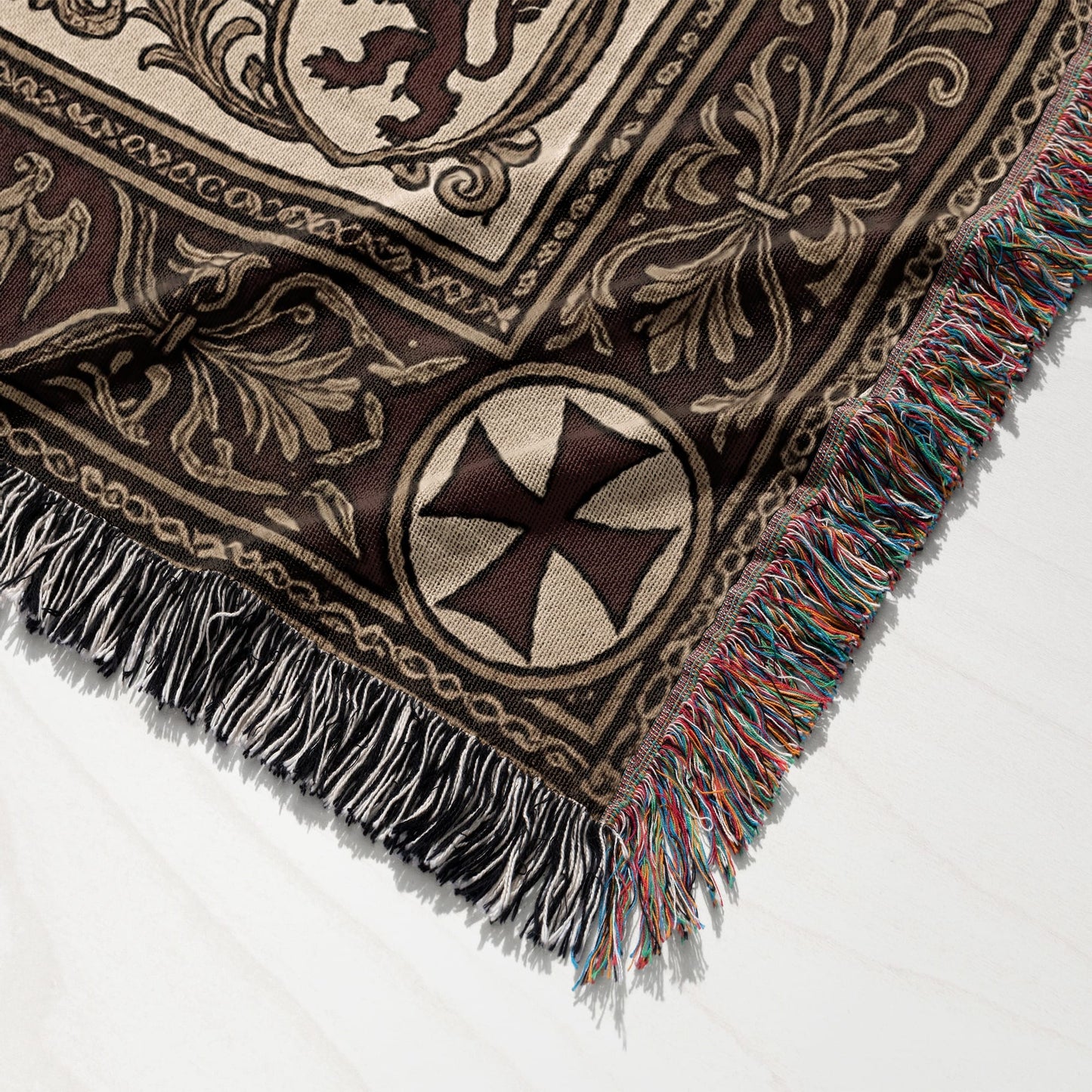 Brown woven throw blanket with medieval-style patterns and tasseled edges.