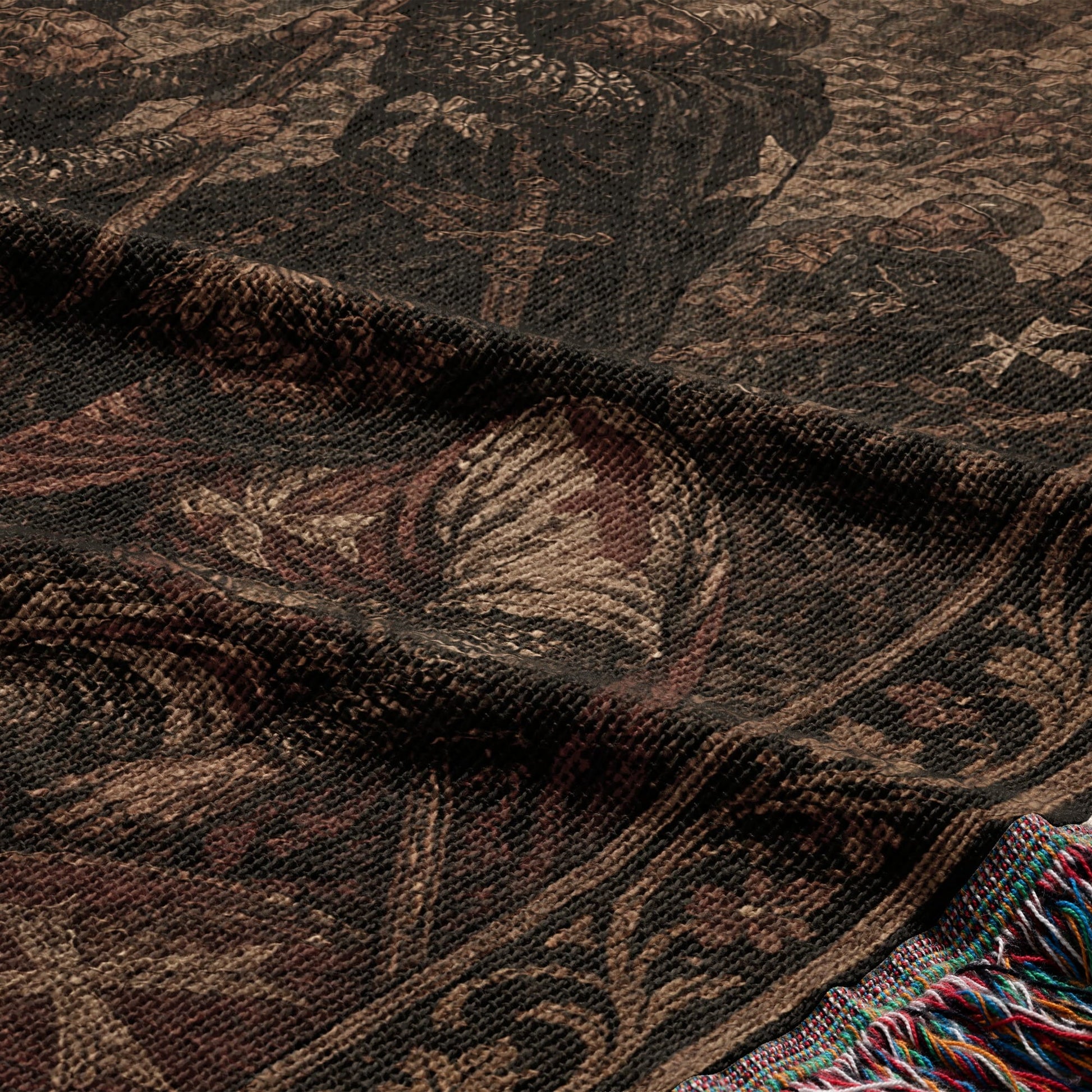 Dark tapestry with intricate, muted medieval-style pattern and fringed edge.