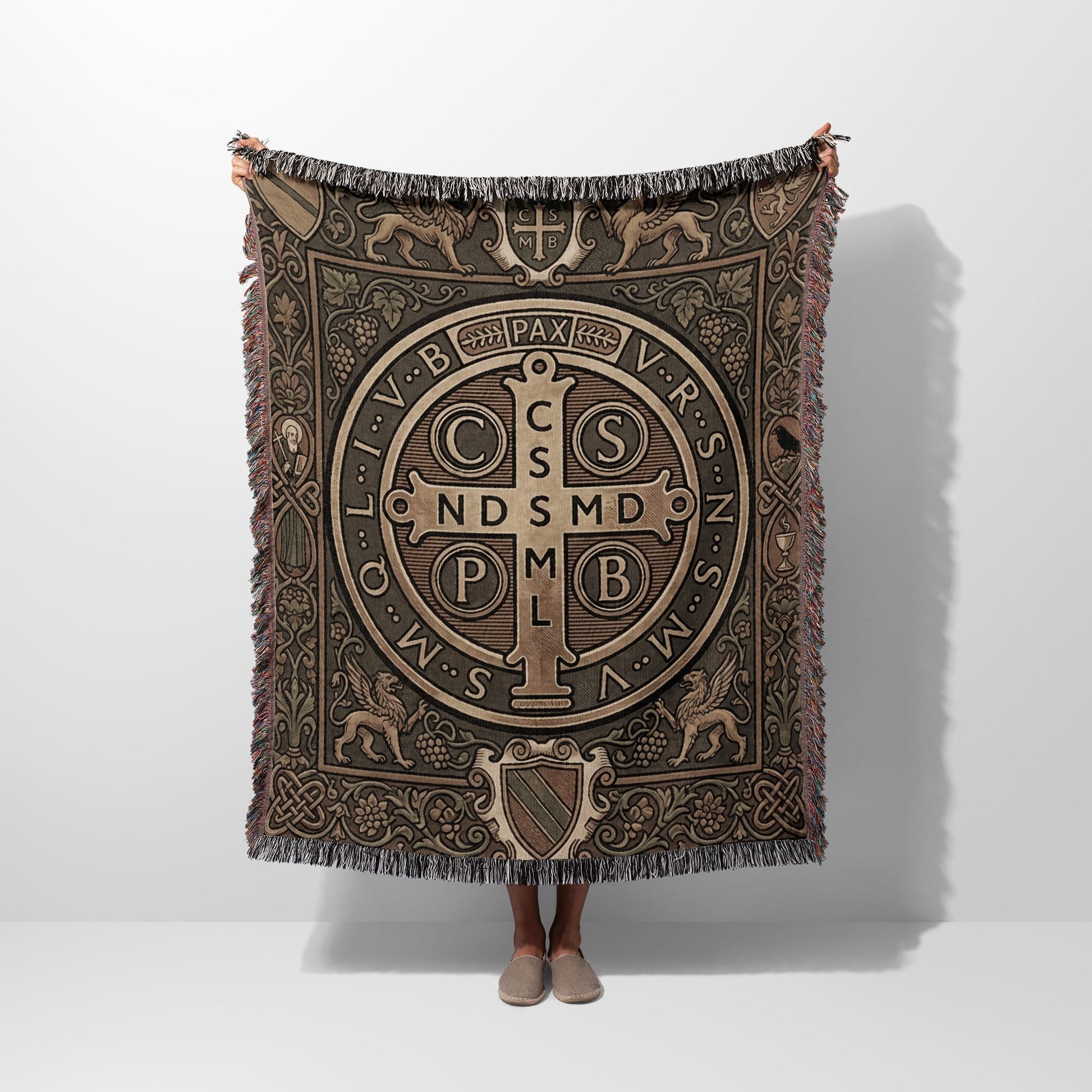 Woven blanket with St. Benedict medal design, featuring griffins and Celtic knotwork.