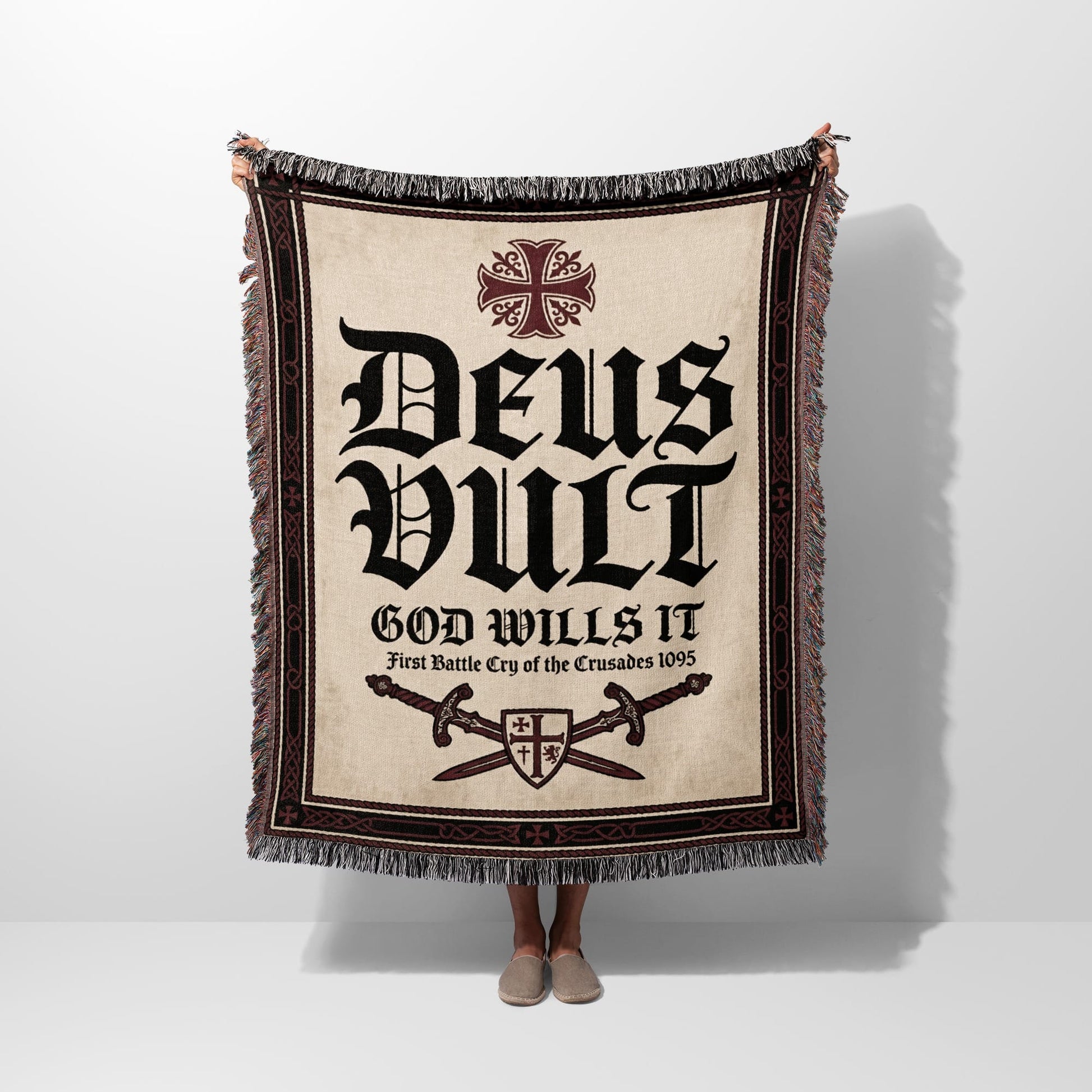 Tapestry blanket with "Deus Vult" and crossed swords design.